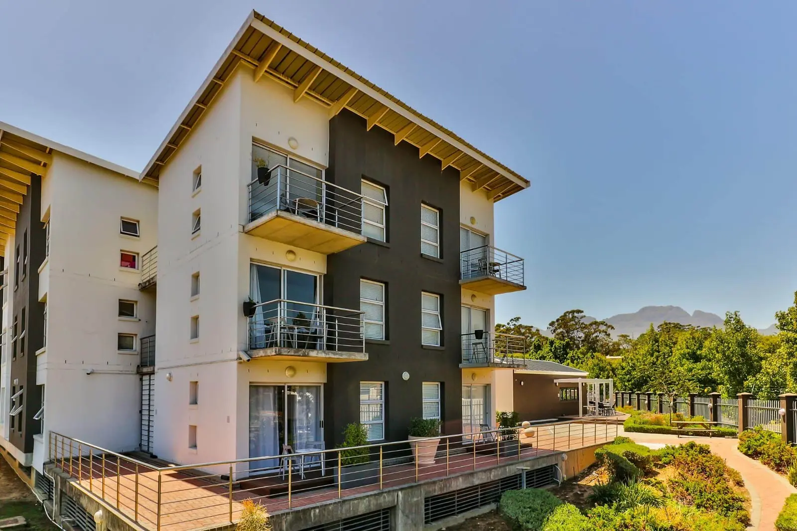 WINK Quivertree apartment building with balconies and a mountain behind